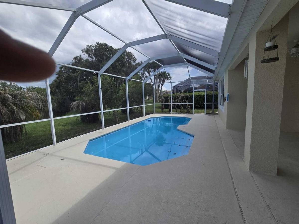 Kissimmee pool deck and screen enclosure before cleaning