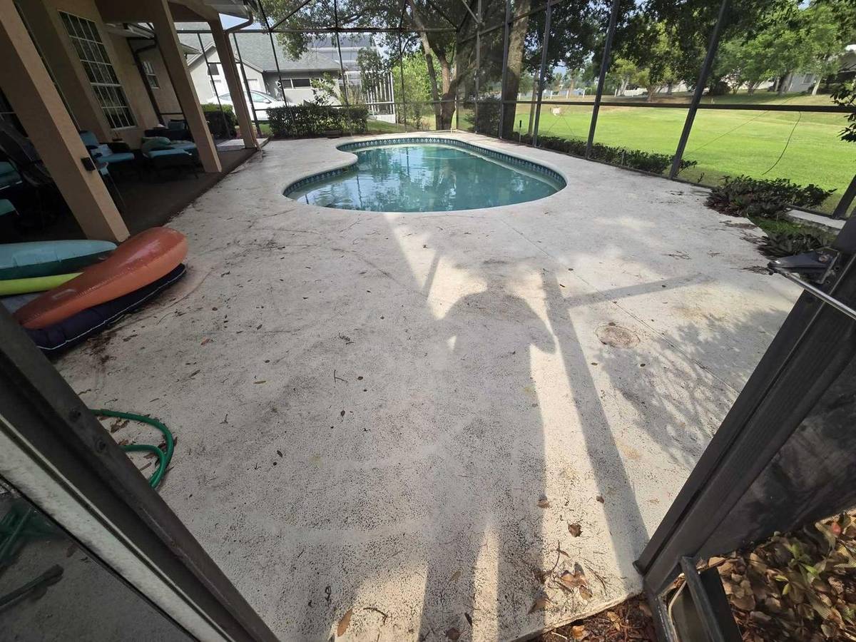 Orlando pool deck and screen enclosure before cleaning