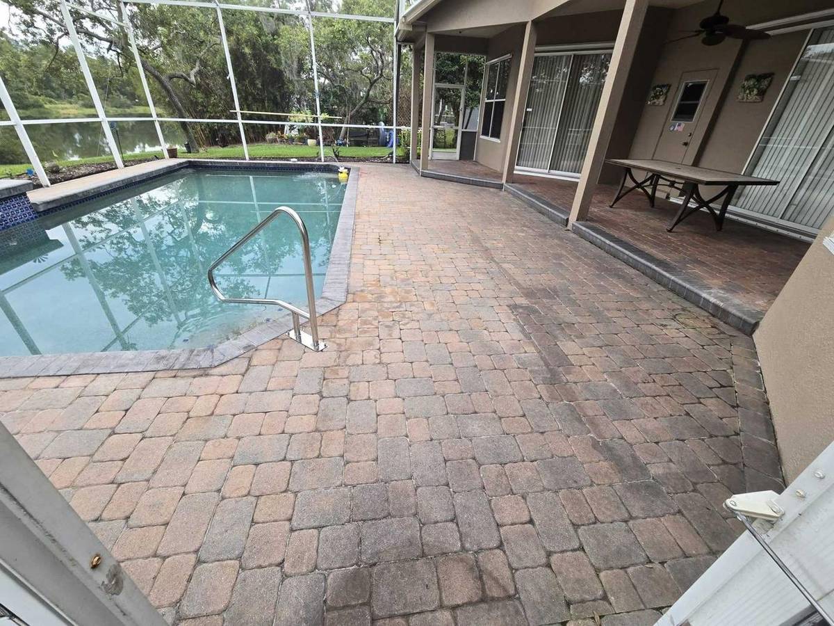 Oviedo pool enclosure and pavers before cleaning