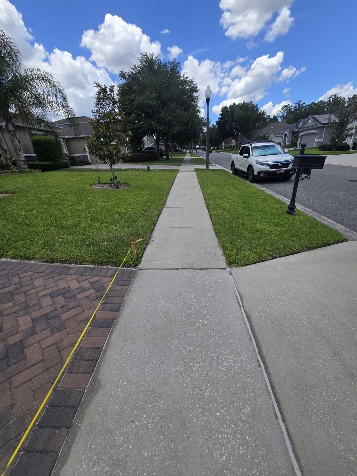 Community sidewalk being pressure washed