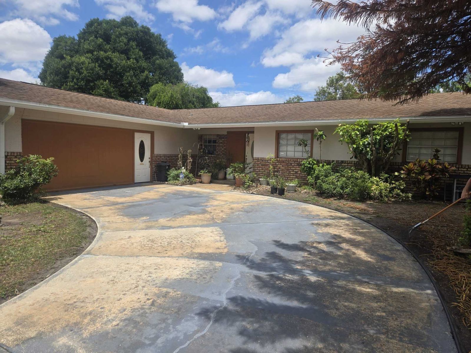 Freshly cleaned driveway with irrigated landscaping and lawn in Central Florida