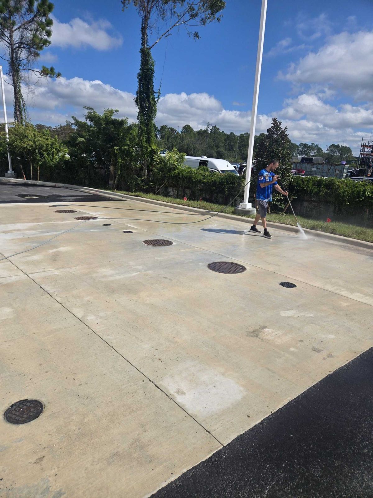 Commercial pavement being pressure washed